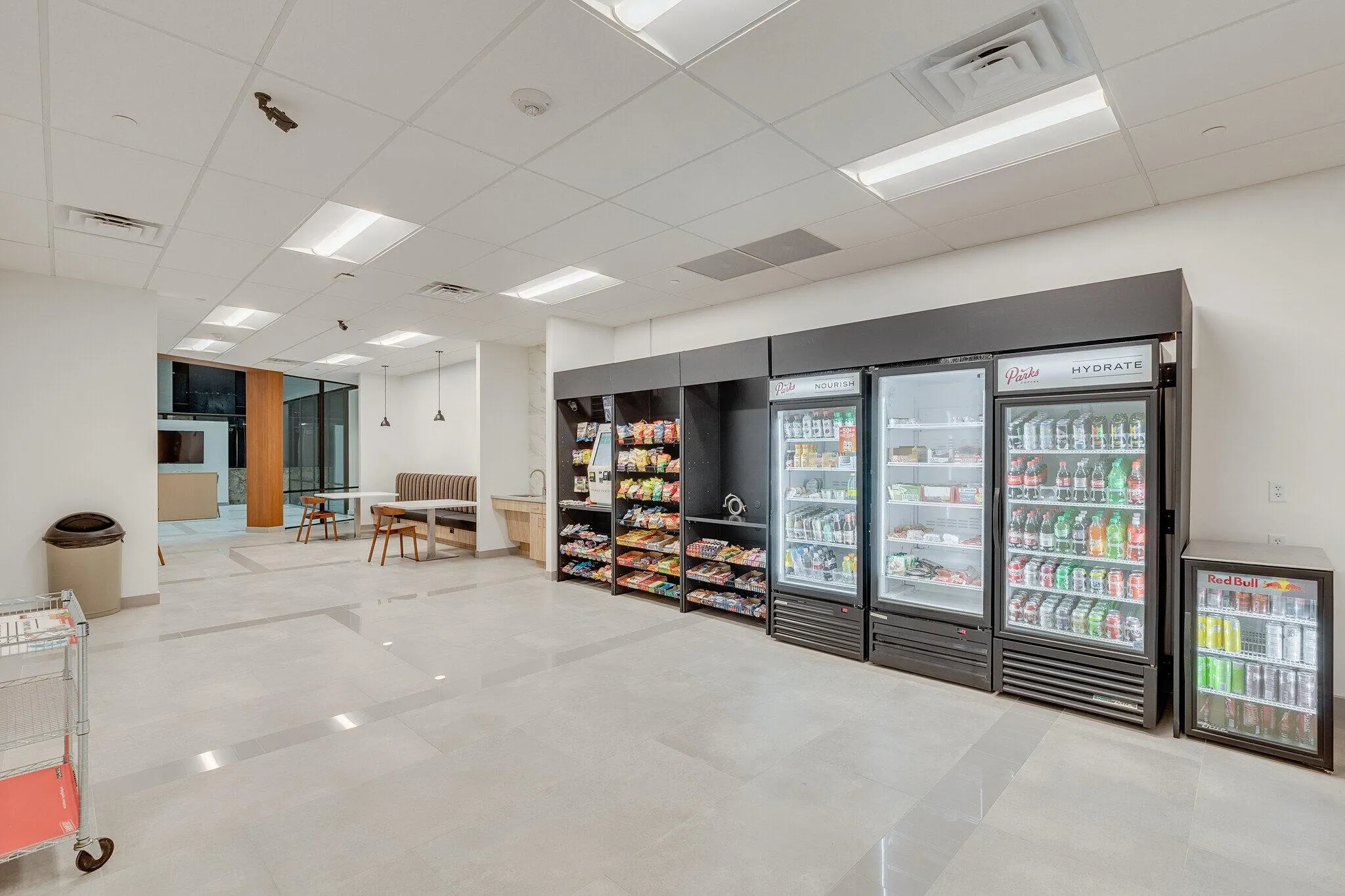 Break room micro market with shelves, coolers, and a self-checkout kiosk