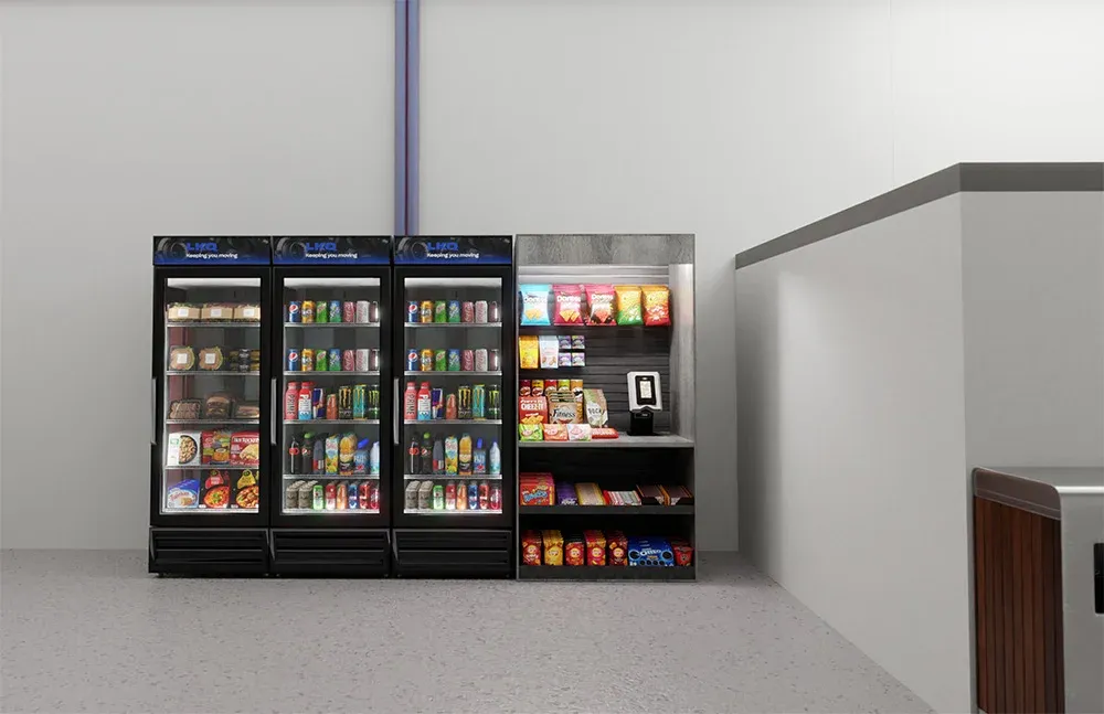 Warehouse break area with three glass-door coolers and a snack rack with a card reader