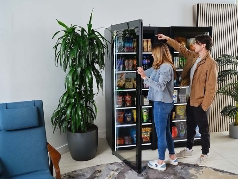 people interacting with a commercial smart cooler or self-service "smart store"