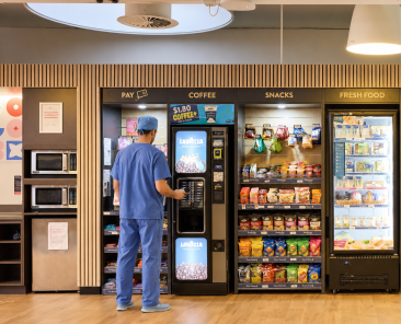 man in blue scrub at a micromarket getting coffee at Irving Texas