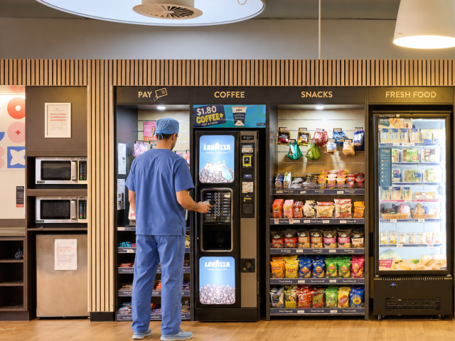 man in blue scrub at a micromarket getting coffee at Irving Texas