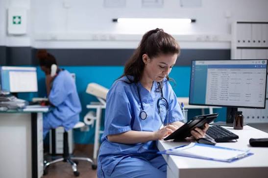 nurse finishing charting near midnight in a Dallas Hospital